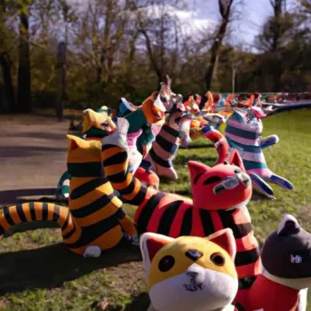 A stampede of happy felt plushie cats in a park during the day, captured in a long shot. (3).jpg
